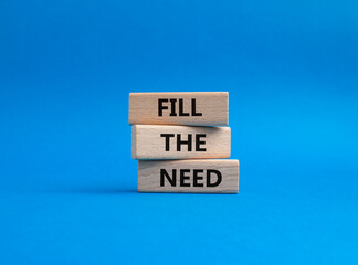Fill the need symbol. Concept word Fill the need on wooden blocks. Beautiful blue background. Business and Fill the need concept. Copy space