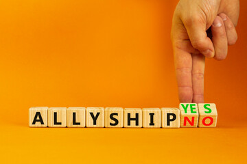 Allyship yes or no symbol. Concept words Allyship yes or Allyship no on wooden cubes. Businessman hand. Beautiful orange table orange background. Business Allyship yes or no concept. Copy space.
