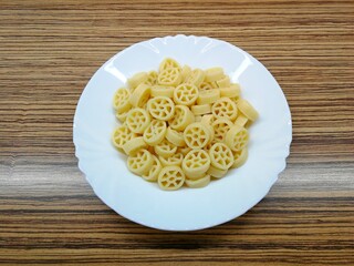 Pasta in the shape of wheels, on a white porcelain plate