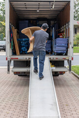 Professional mover carrying furniture - 533457585