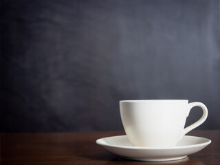 Close up white coffee cup on wood table dark background