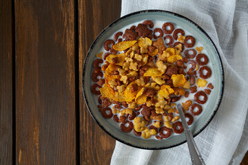 Variety of cold cereals, quick breakfast for kids. Brown wooden background