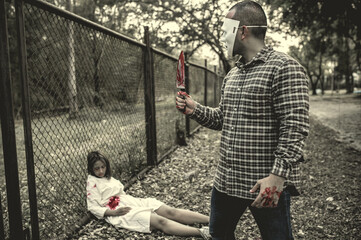 A serial killer scene is about to kill an Asian woman,concept thriller scene,Halloween festival