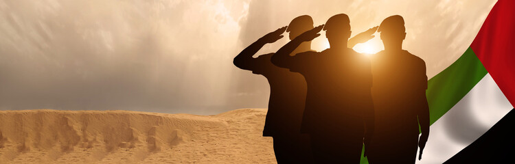 Silhouette Of A Solider Saluting Against the flag of UAE. Concept of national muslim holidays....