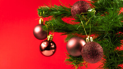 Christmas tree with shiny decorations on the red background. Christmas concept idea. Winter holiday season.