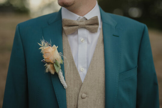 groom in suit with bow