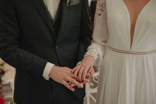 bride and groom showing their rings
