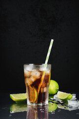 Cuba libre cocktail with lime.
