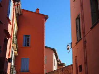 colorful blue shutters on orange painted building