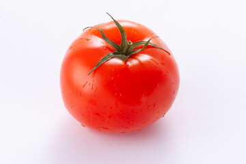 Ripe washed tomato. isolated on white.