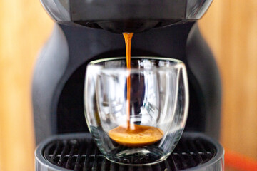 Espresso black coffee without any added creamer, pulling espresso coffee through pressure