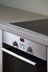 induction hob and built-in electric oven at modern kitchen
