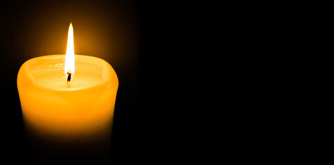 Banner. White candle burns on a black background. Place for the text, postcard. The concept of grief,sorrow, sadness saving light, copy space,mocap, religion