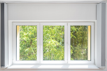 pvc window and vertical blinds in apartment room