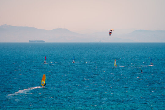 Windsurfers sailing on blue ocean water