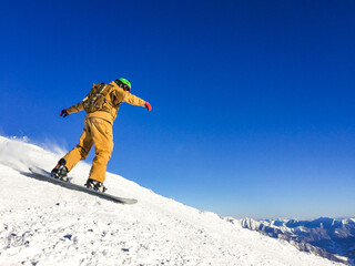 Snowboarder freerider in high mountains