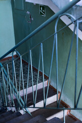 Railing of an old green staircase, stairs in the entrance, selective focus