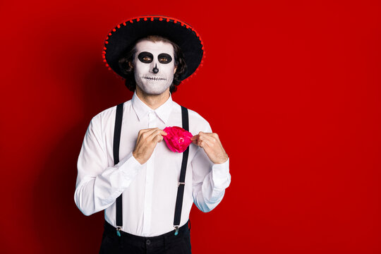 Portrait of his he handsome scary content cheery imposing guy gentleman wearing sombrero adjusting festal accessory Santa Muerte cult ritual isolated bright vivid shine vibrant red color background
