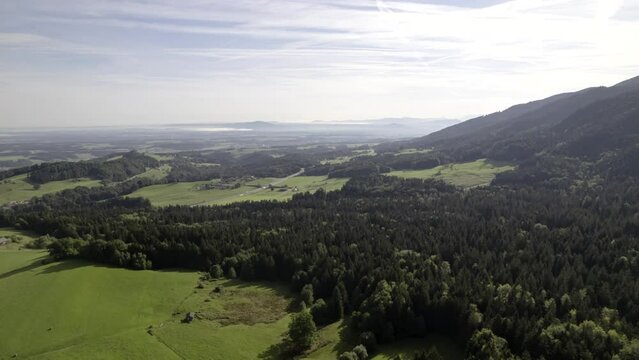 Aerial time lapse shot of the Chiemgau Alps and its forests and meadows on a nice morning in late summer