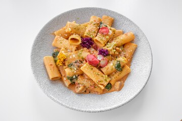 Vegetable Rigatoni served in a dish isolated on grey background side view