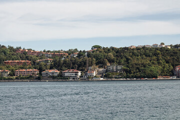 Fototapeta na wymiar View of Kanlica and Beykoz areas by Bosphorus on Asian side of Istanbul. It is a sunny summer day. Beautiful travel scene.