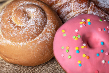 Sweet homemade freshly baked bun on the table. Close-up.