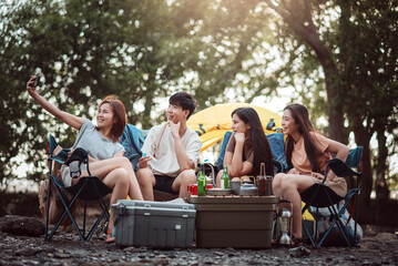 Group of friends at campground, Camping tent with friends, Diverse asian young family hangout together at camp yard. Outdoor activity and leisure on holiday.