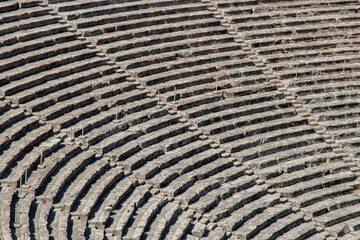 Stone seats of an ancient Greek theater in sunny day