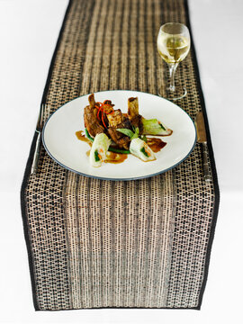 Grilled Pork Ribs With Chinese Cabbage Rolls (Iga Babi Mepanggang) At A Restaurant In Sanur, Bali, Indonesia.