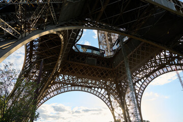 Eiffel Tower from underneath looking up into the beautiful structure and seeing the steel beams