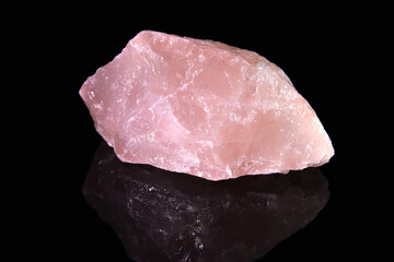 An uncut shard of the mineral rose quartz with whitish veins