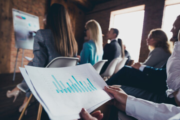 Portrait of business people sit conference room check annual results graph report loft office indoors