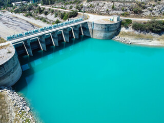 Aerial view of water reservoir, concrete rapid and closed reservoir locks of a dam. Berdan dam, Tarsus, Mersin province, Turkey