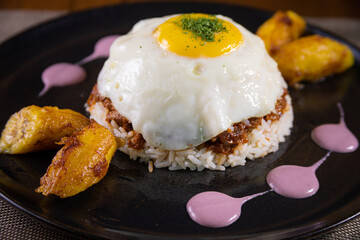 Typical peruvian food, rice with egg and sweet banana