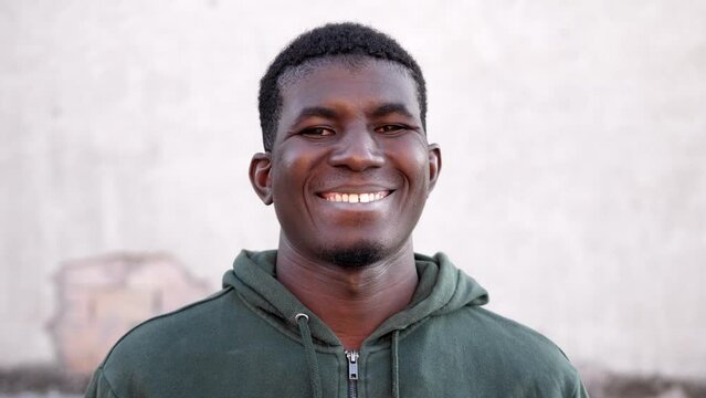 Positivity-young african man looking at camera and smiling