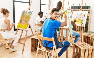 Group of people smiling happy drawing at art studio.