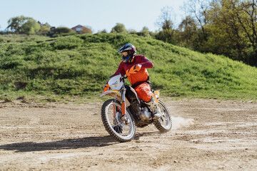 Fototapeta na wymiar Extreme and Adrenaline. Motocross rider in action. Motocross sport. Active lifestyle.