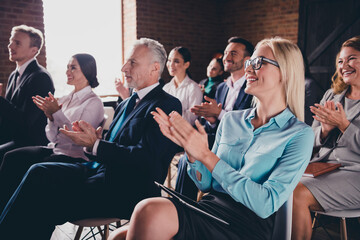 Photo of cheerful positive hrs sitting boardroom successfully pass training workplace workstation