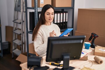 Young woman ecommerce business worker using touchpad at office