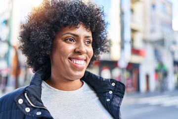 African american woman smiling confident looking to the side at street