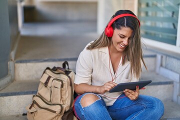 Young hispanic woman student smiling confident watching video on touchpad at university