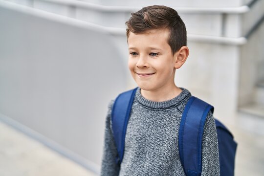 Blond child student smiling confident standing at school