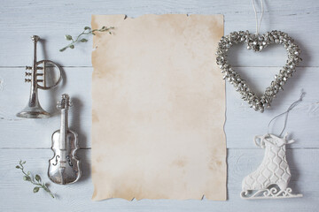 White winter wooden background and paper for text, musical instruments, trumpet, violin, heart of...