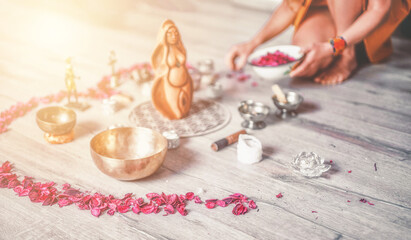 Beautiful altar with rose petals and goddess statuette. ceremony space.