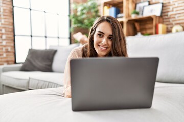 Young hispanic woman smiling confident using laptop at home