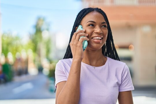 African american woman smiling confident talking on the smartphone at street
