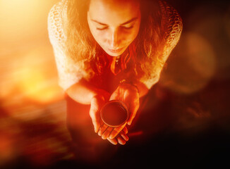 Cacao ceremony, heart opening medicine. Ceremony space. Cacao cup in woman's hand.
