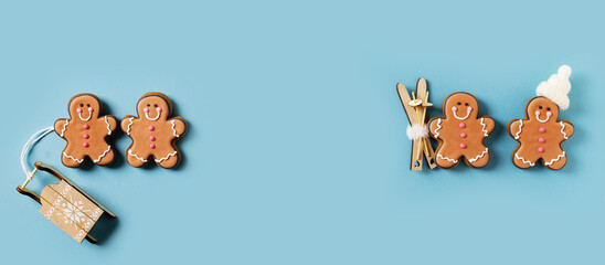 Row gingerbrads men on stick on blue background