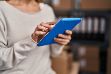 Young woman ecommerce busines worker using touchpad working at office