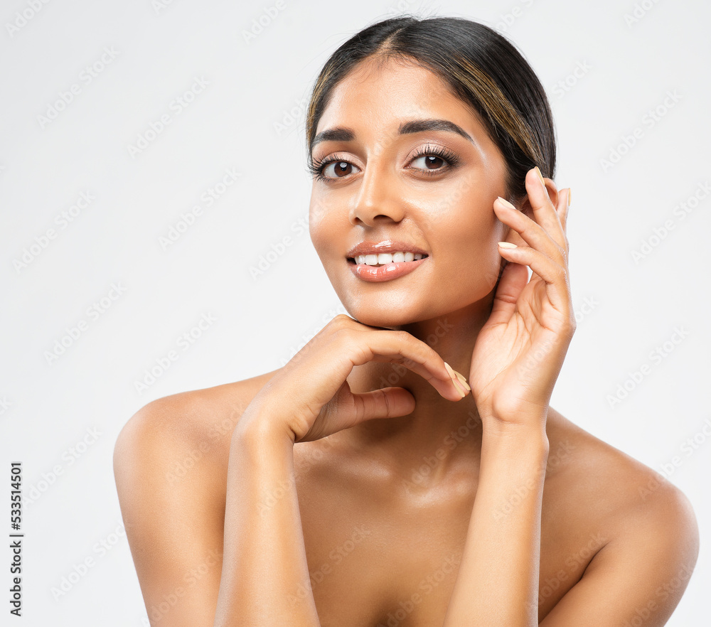 Wall mural Woman Face Skin Care Cosmetic. Indian Beauty Model showing Perfect Chin and Cheekbones. Women Facial Treatment and Health. Beautiful Girl doing Anti Aging Face Lift Massage over White